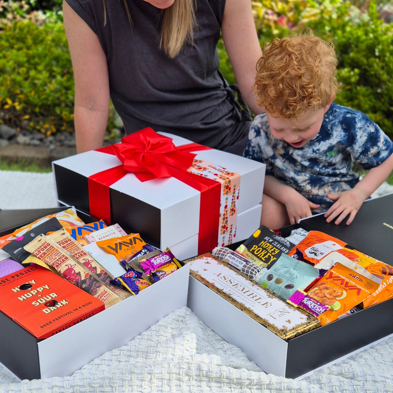 Mother and son opening festive gift box