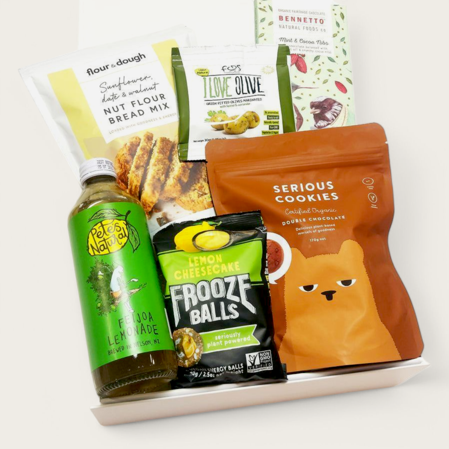 Gluten Free & Dairy Free gift box with frooze balls, cookies, drink, bread mix, olives & Chocolate. Presented in a modern gift box.