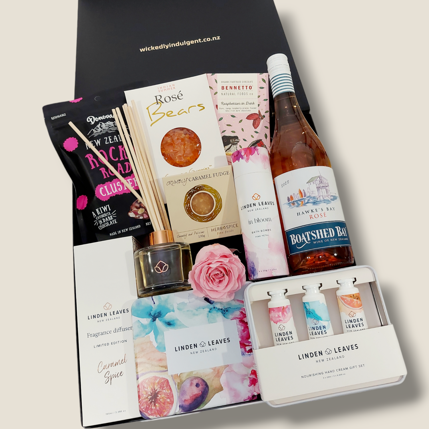 Superwoman pamper gift hamper with room diffuser, bath bombs, handcreams, preserved rose and sweet treats. Presented in a modern gift box.