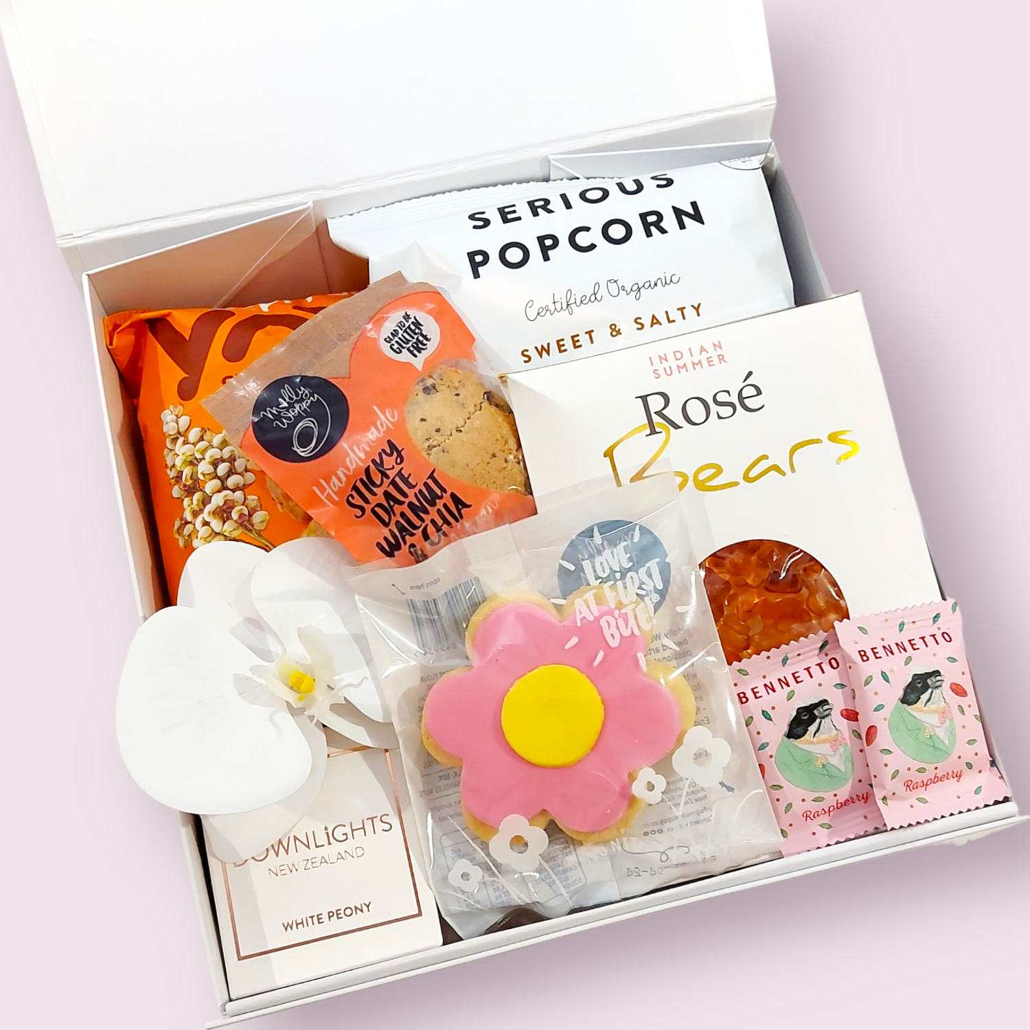 Little luxuries gift box with candle, flower and sweet treats. Presented in a modern gift box.