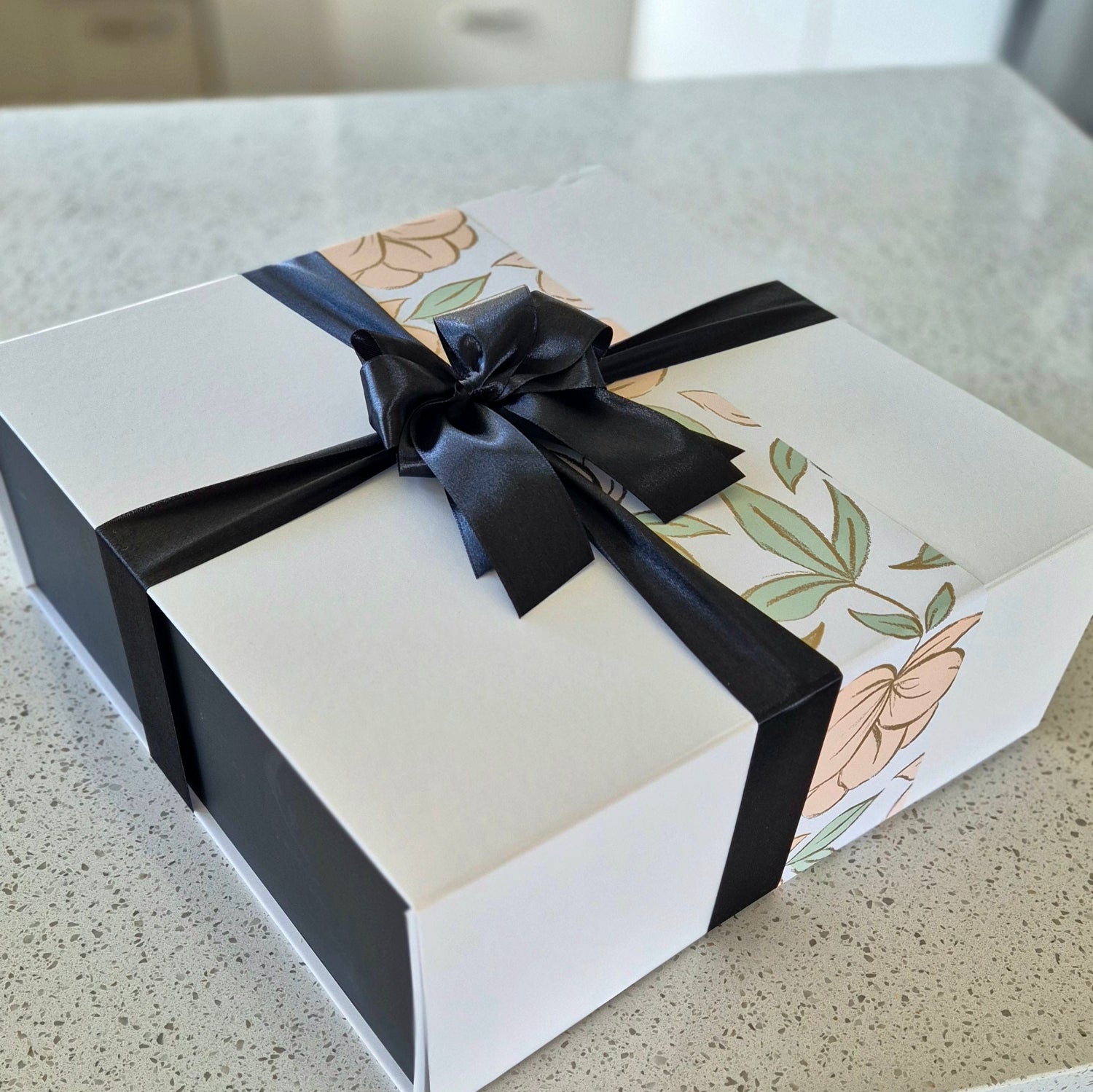 Elegant settlement gift box with black satin ribbon and floral wrap – ideal for real estate clients in New Zealand.