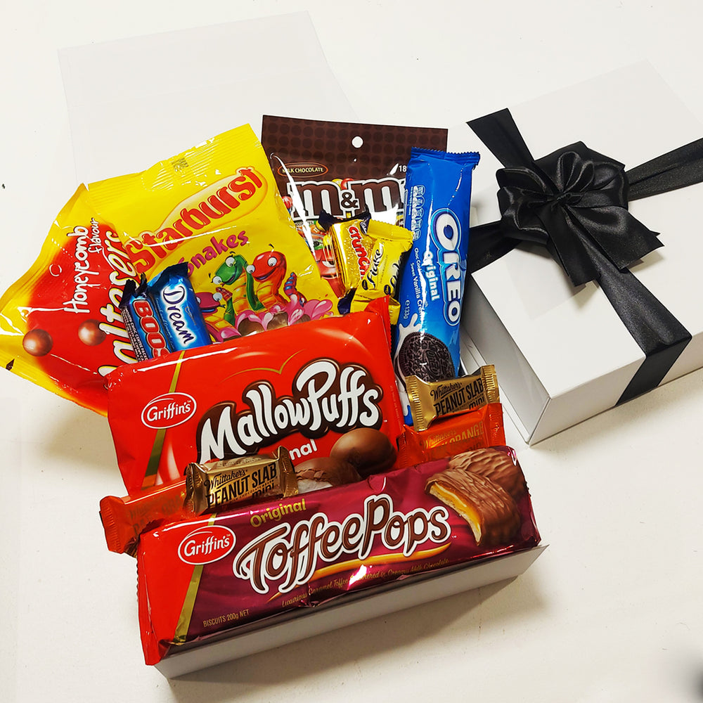 Chocolate lovers gift baskets with Whittakers, Maltesers, & MallowPuffs presented in a modern gift box.