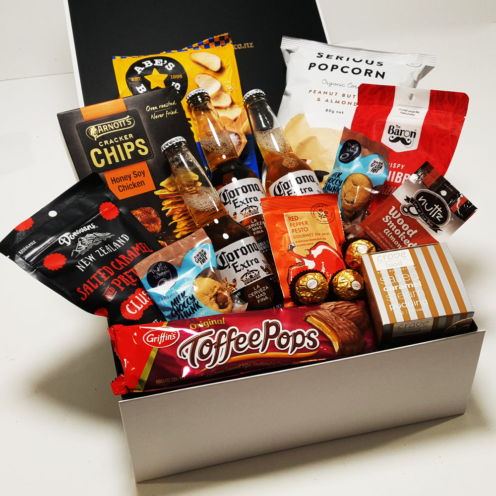 Covid Cabin Fever Gift Basket with Corona Beer, Popcorn, Toffee Pops, Chocolate & More presented in a modern gift box.