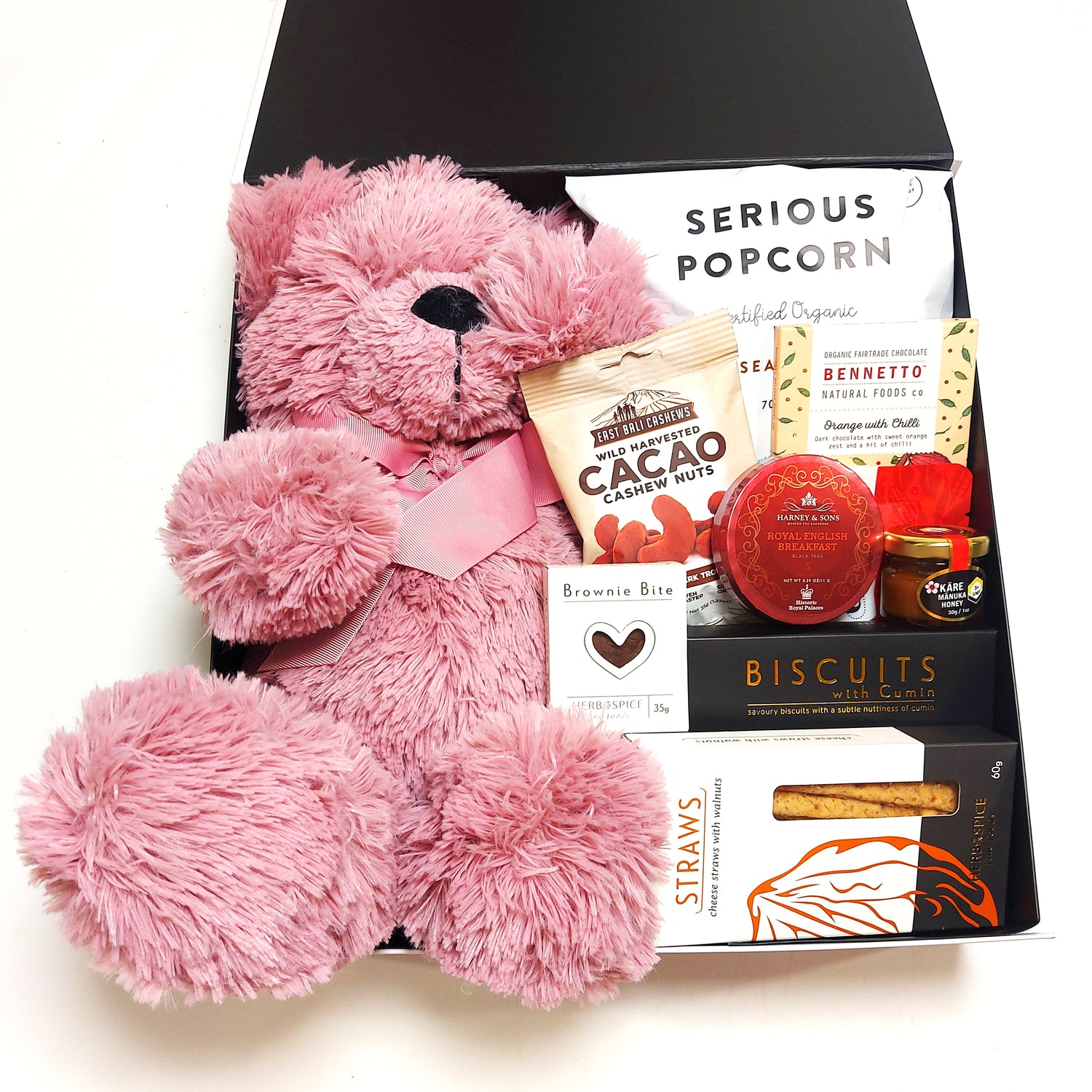 Baby love gift basket with pink teddy, honey, popcorn, biscuits & nibbles. Presented in a modern gift box.