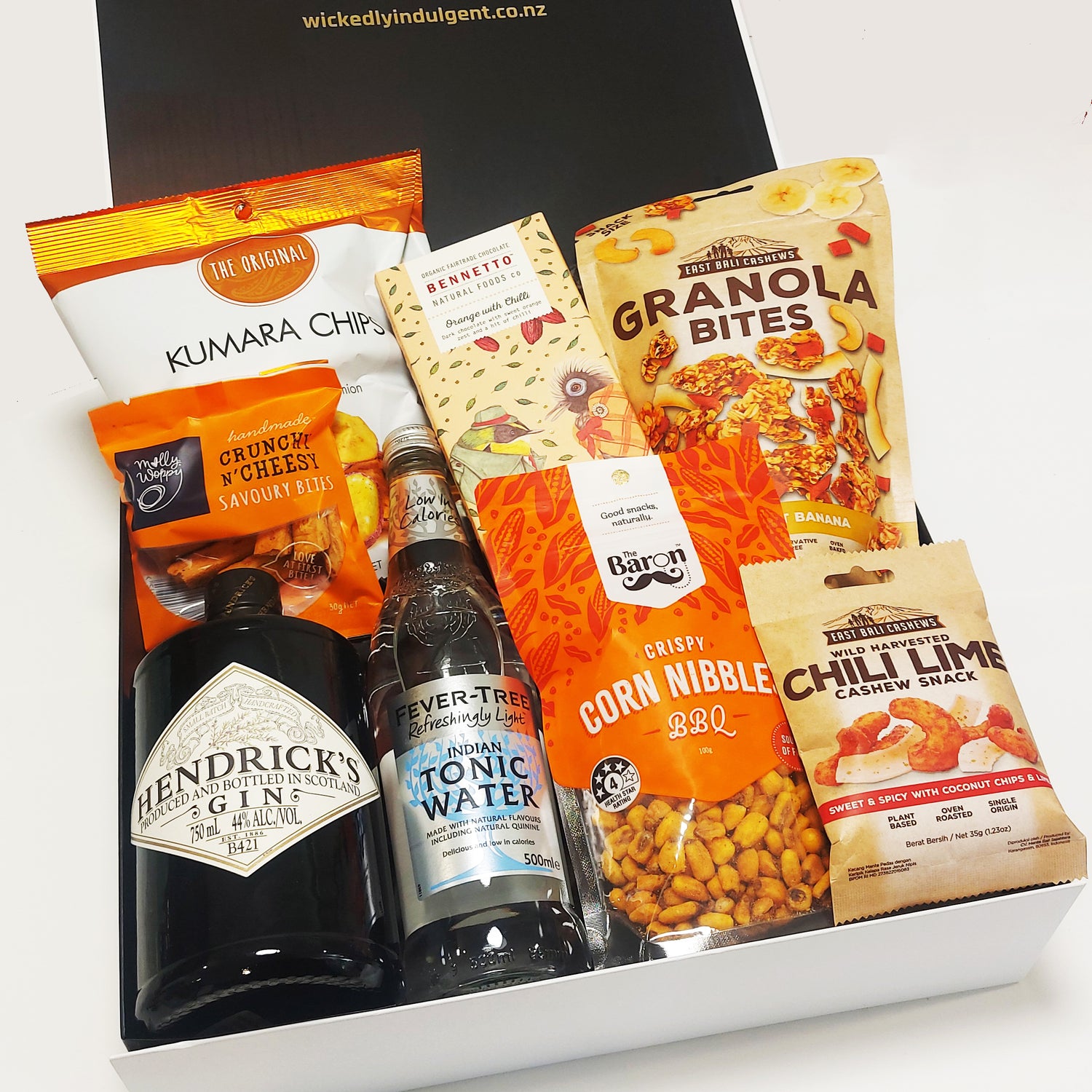Gin for the win gift basket with Hendricks gin, fever tree tonic, chocolate, chips and nibbles. Presented in a modern gift box.