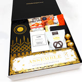 House warming gift box with Champagne, Diffuser, Candle, Chocolate, Nuts, Gingerbread & more. Presented in a modern gift box.