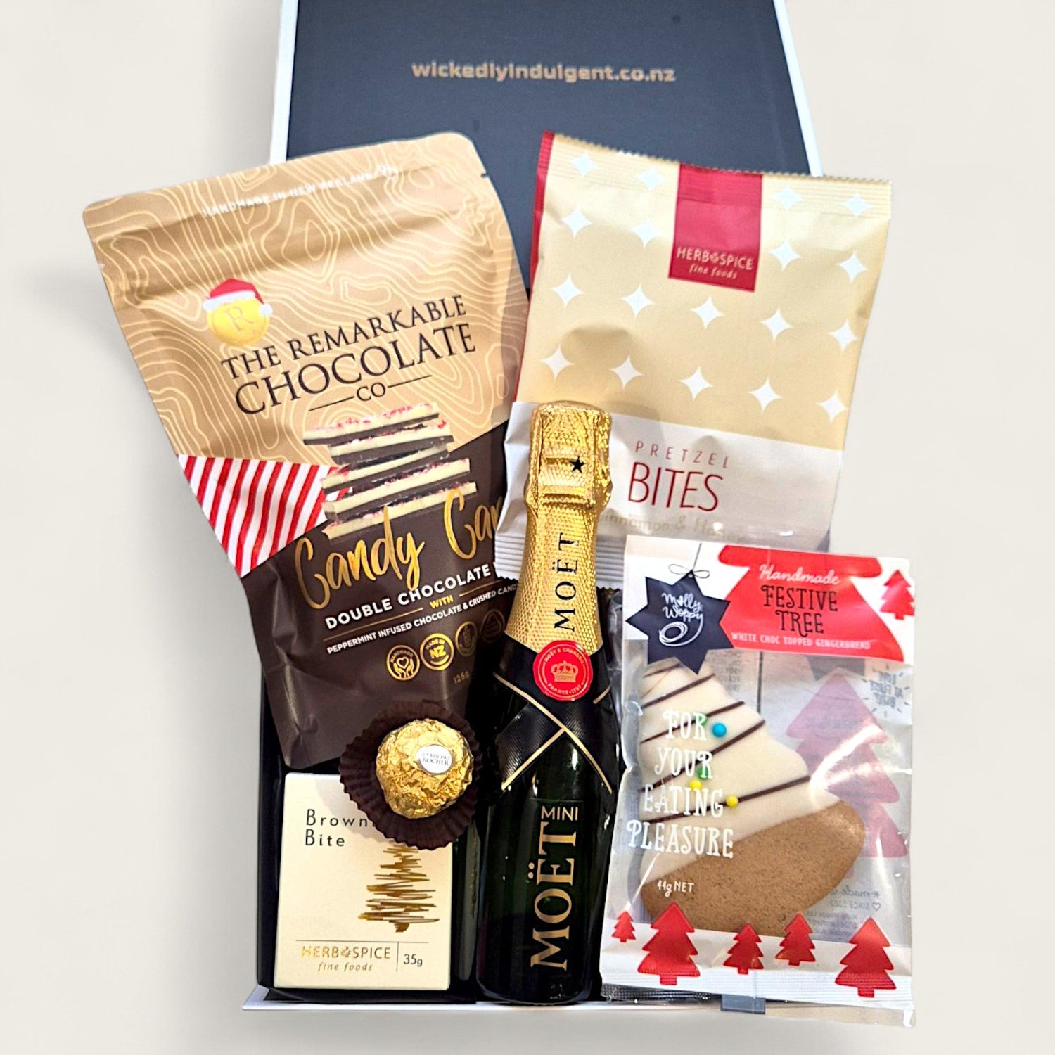 Christmas gift hamper with Moët mini champagne, chocolate bark, shortbread, brownie bite, and festive packaging – Bells & Whistles gift box.
