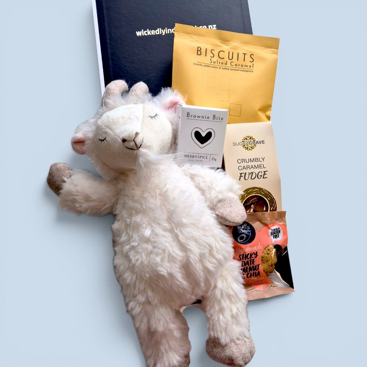 Billy Goat Cuddles new baby gift box with a soft billy goat plush, chocolate, biscuits and treats for new parents.