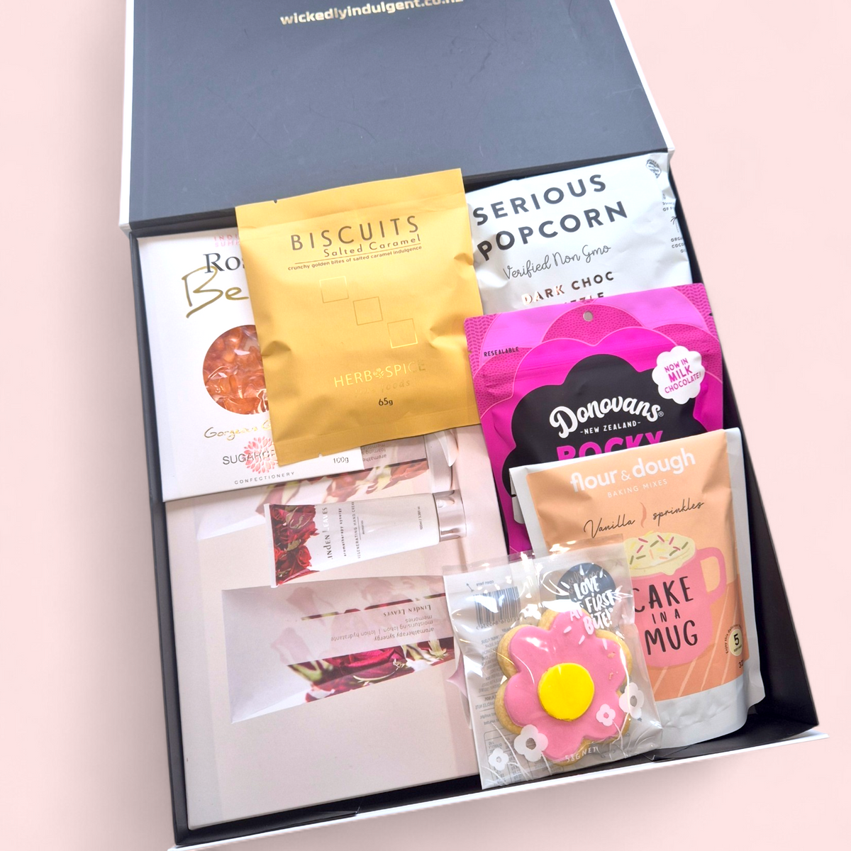 Pink themed gift hamper for Mum with self care products and indulgent treats, beautifully packaged NZ delivery