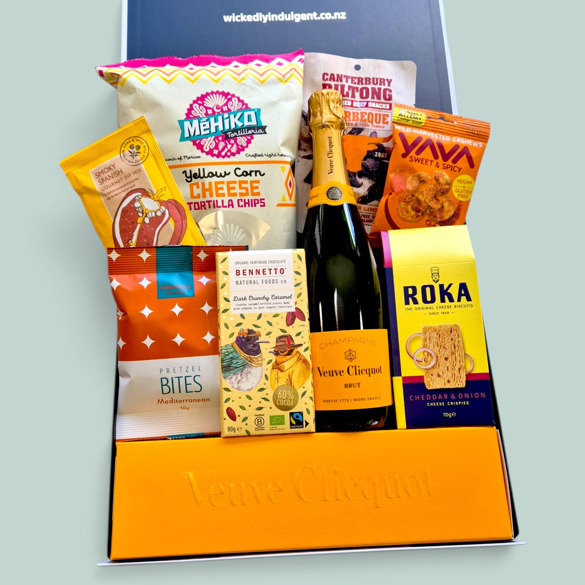 Luxury Champagne gift hamper with Veuve Clicquot, savoury snacks, biltong, chocolate, cheese crispies, cashews and treats, delivered NZ wide.