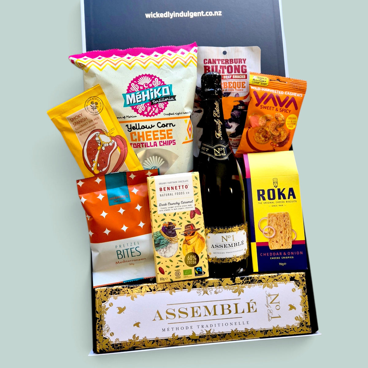 Premium bubbles gift box with choice of Champagne or sparkling wine, savoury grazing snacks, tortilla chips, dip, biltong and chocolate.