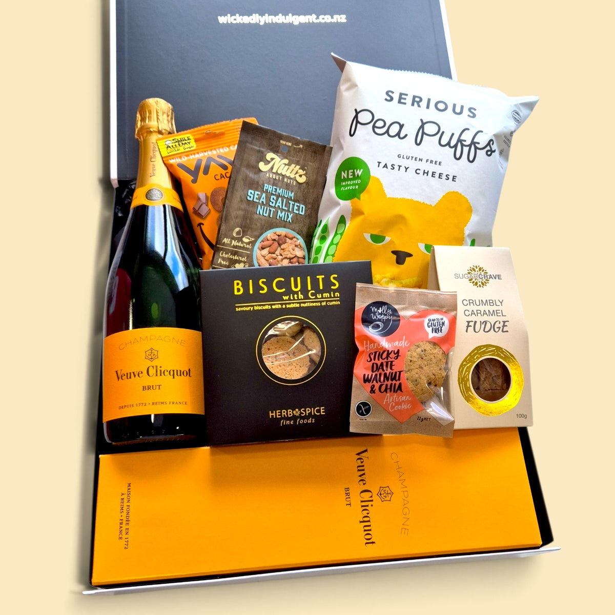 Champagne Is To Blame gift hamper with Veuve Clicquot Champagne, gourmet biscuits, fudge, pea puffs, nuts and cacao cashews.