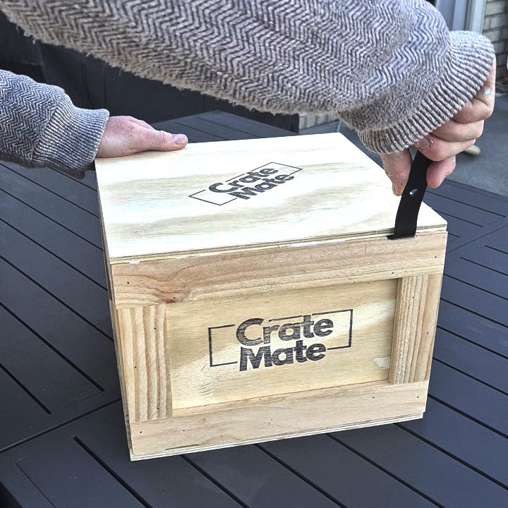 wooden crate being opened with a crowbar