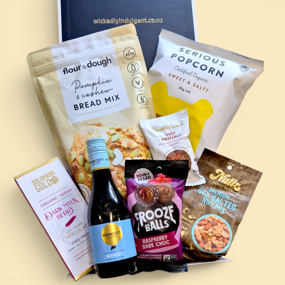 Dairy free wine gift box with mini Merlot, pumpkin and cashew bread mix, dairy free chocolate, popcorn, nuts and sweet treats.