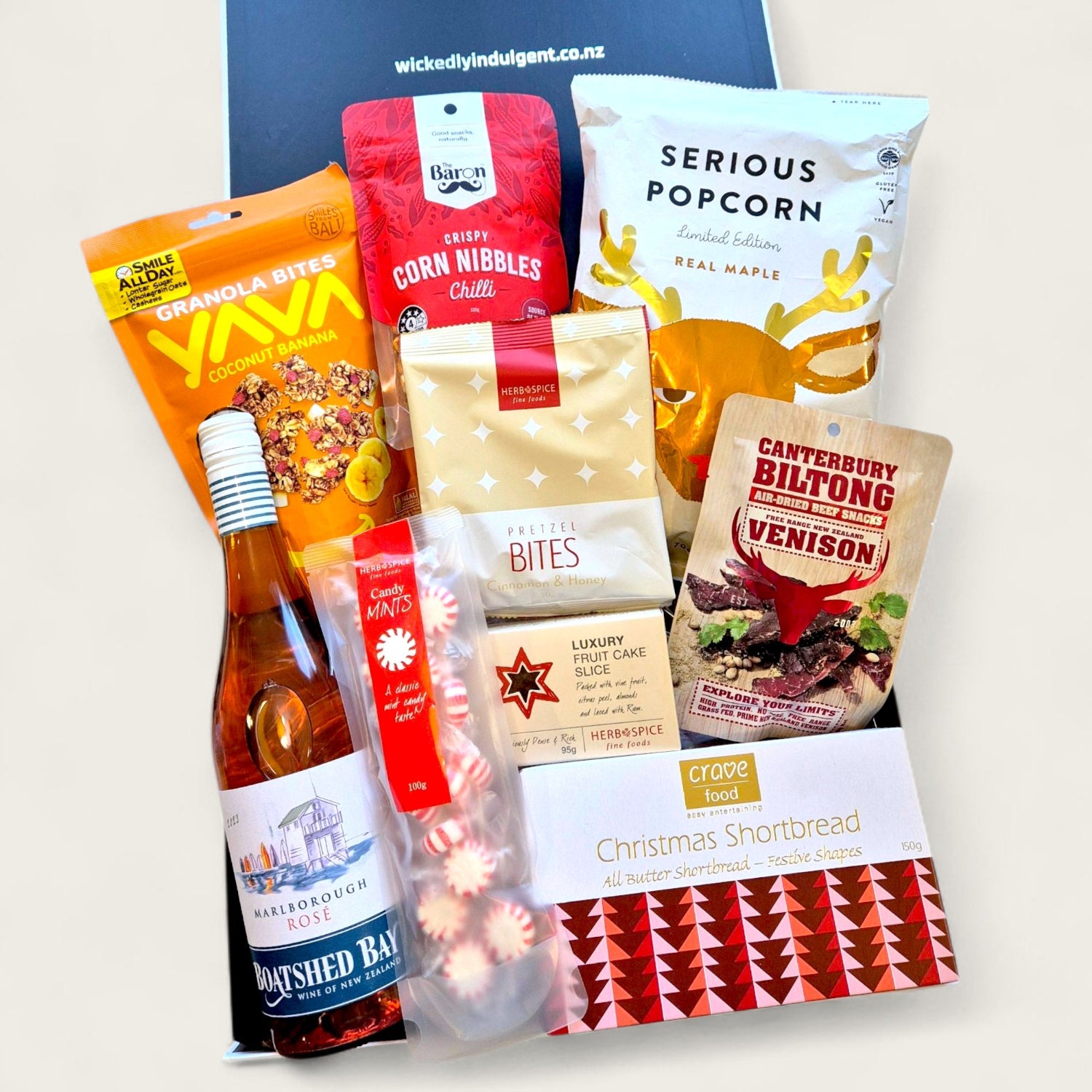 Festive Christmas gift box packed with wine, venison biltong, serious popcorn, luxury shortbread, and holiday snacks worth unwrapping.