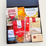 Festive Christmas gift box packed with wine, venison biltong, serious popcorn, luxury shortbread, and holiday snacks worth unwrapping.