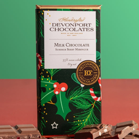 Devonport Chocolates Summer Berry Meringue Milk Chocolate 80g in festive Christmas packaging with pieces of berry and meringue chocolate.