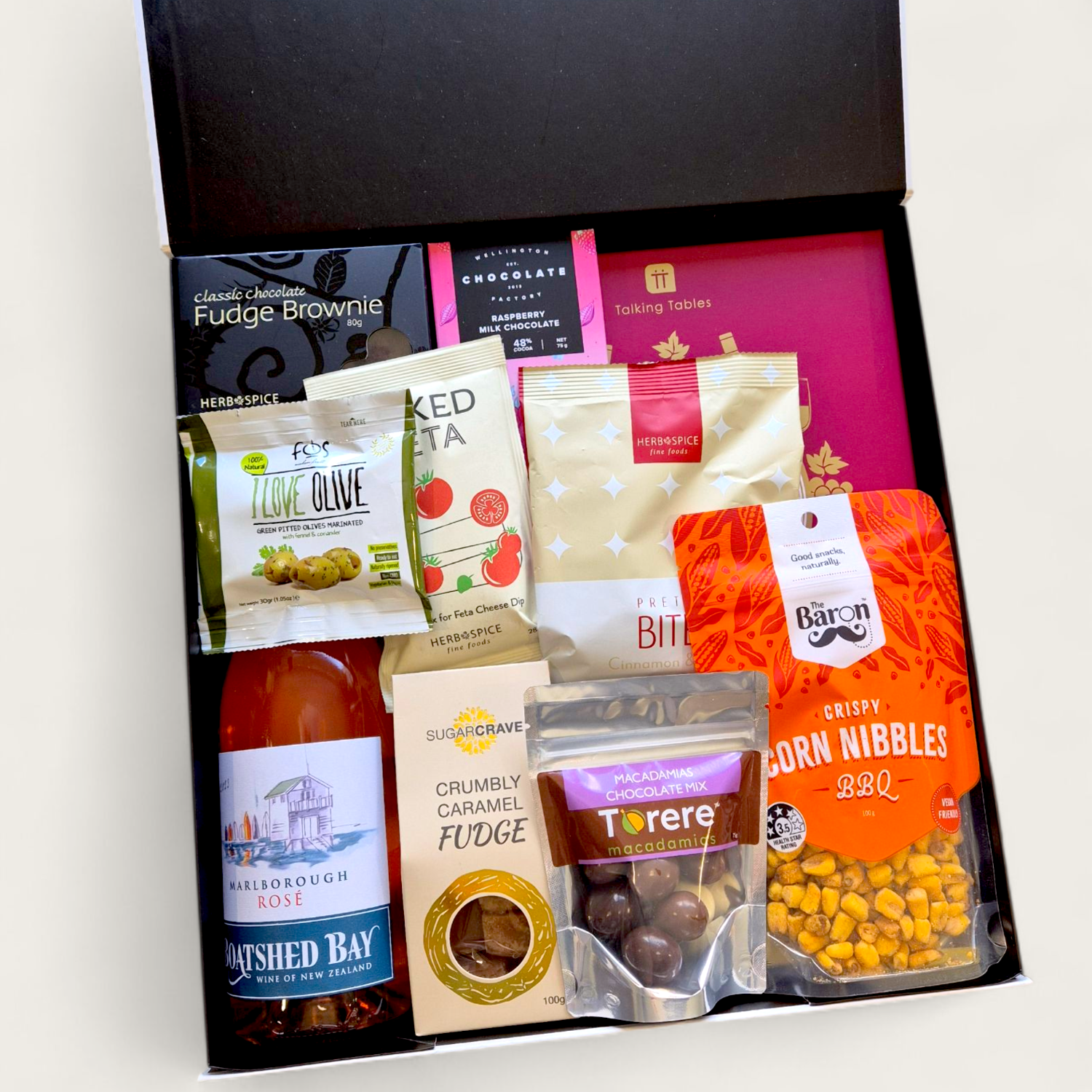 Gourmet wine hamper with board game and snacks, a fun and unique gift idea for wine lovers or corporate teams.