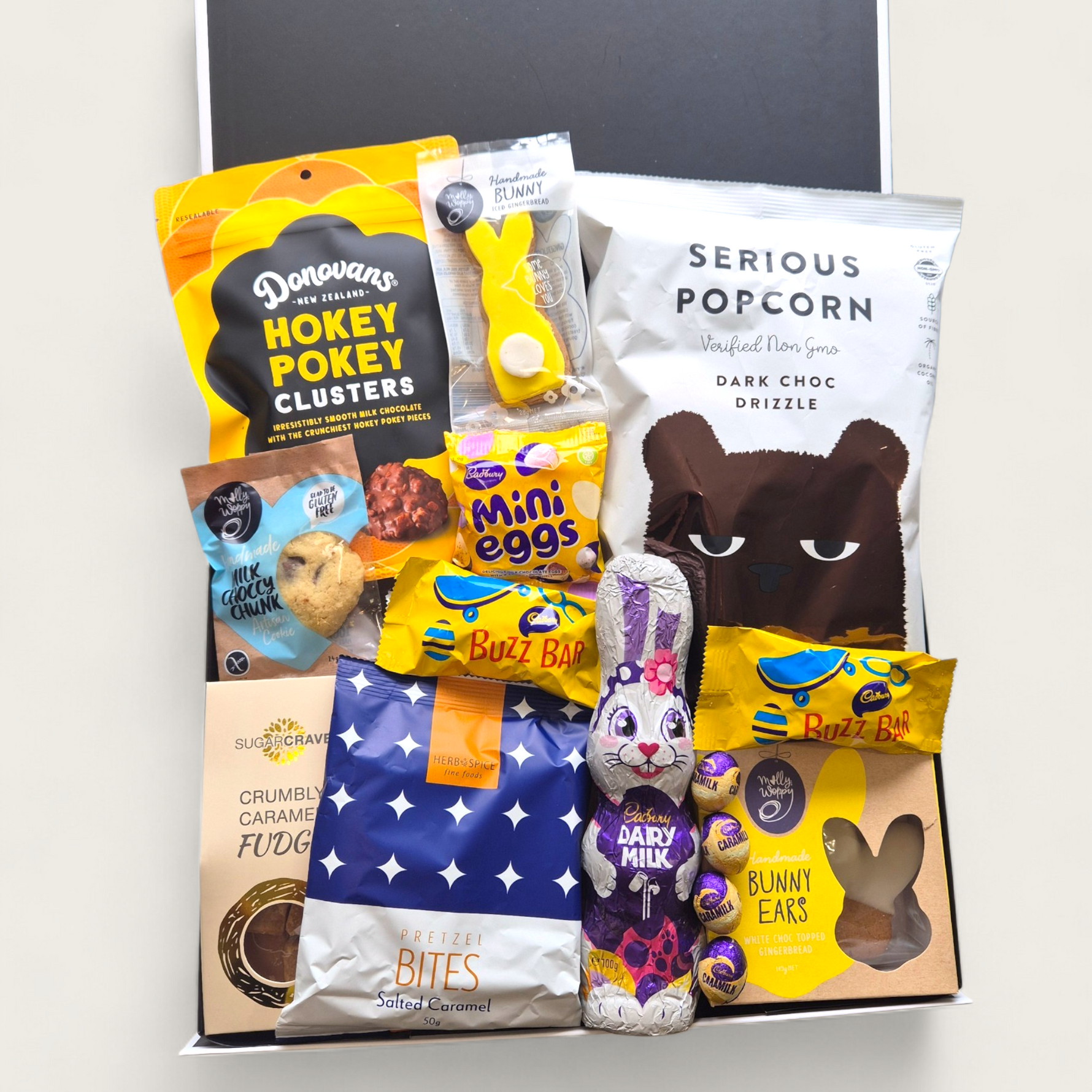 Easter gift hamper with chocolate bunny, Cadbury mini eggs, popcorn and gourmet treats in a curated gift box
