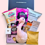 New baby gift box with flamingo wall hanging for nursery decor, baby burp cloth, sweet treats and savoury snacks for new parents.