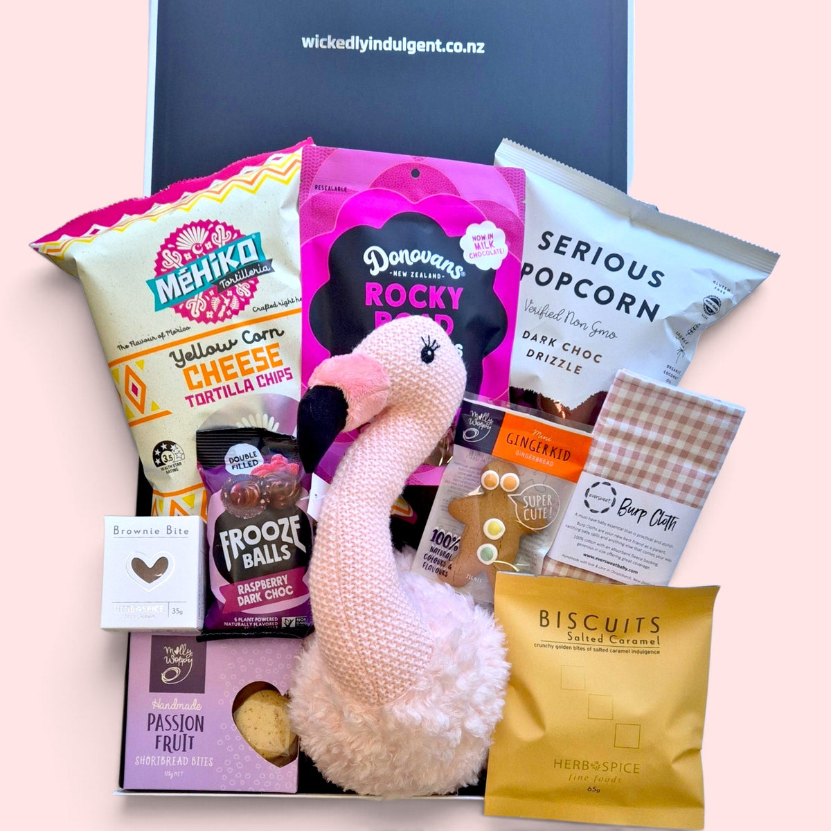 New baby gift box with flamingo wall hanging for nursery decor, baby burp cloth, sweet treats and savoury snacks for new parents.