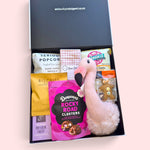 Baby gift box with flamingo nursery wall hanging, burp cloth and treats for new parents.