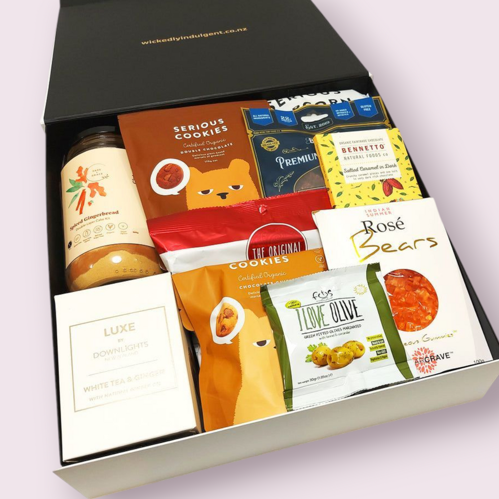 Gluten & Dairy Free Gift Box with candle, cake mix, cookies, jerky, chocolate & more. Presented in a modern gift box.