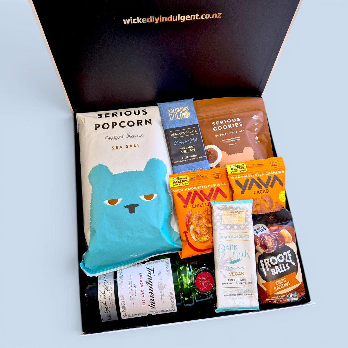 Gluten-free dairy-free gift hamper NZ with Tanqueray, Yava cacao 
cashews, Serious Popcorn, Solomon's Gold chocolate, Frooze Balls and 
East Bali cashews — Wickedly Indulgent you choose the booze gift box