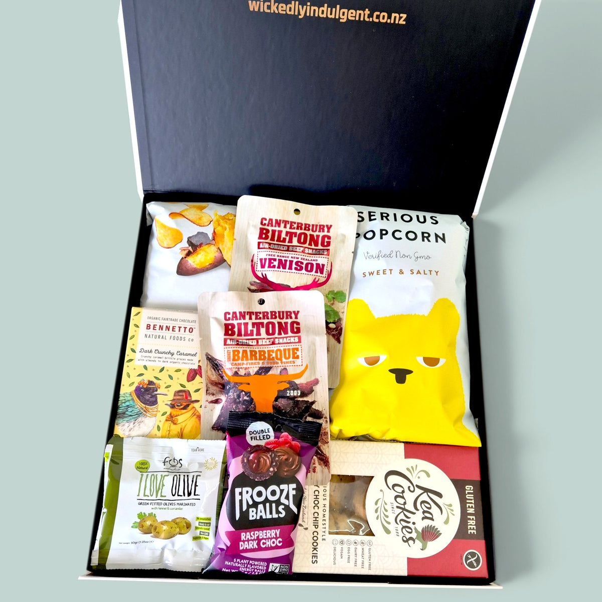 Get In My Belly gift hamper featuring gourmet chocolates, biltong, popcorn, biscuits and sweet and savoury snacks, beautifully presented in a Wickedly Indulgent gift box.