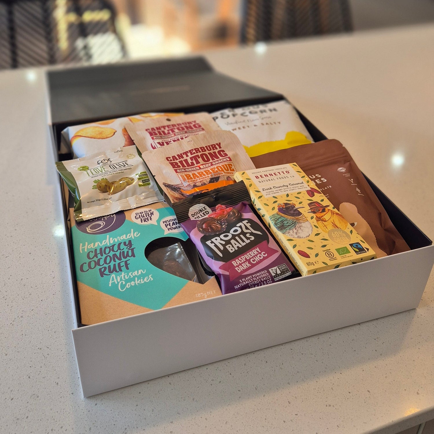Dairy free gift box filled with dairy free chocolate, coconut cookies, popcorn, savoury snacks and treats, beautifully packed for gifting.