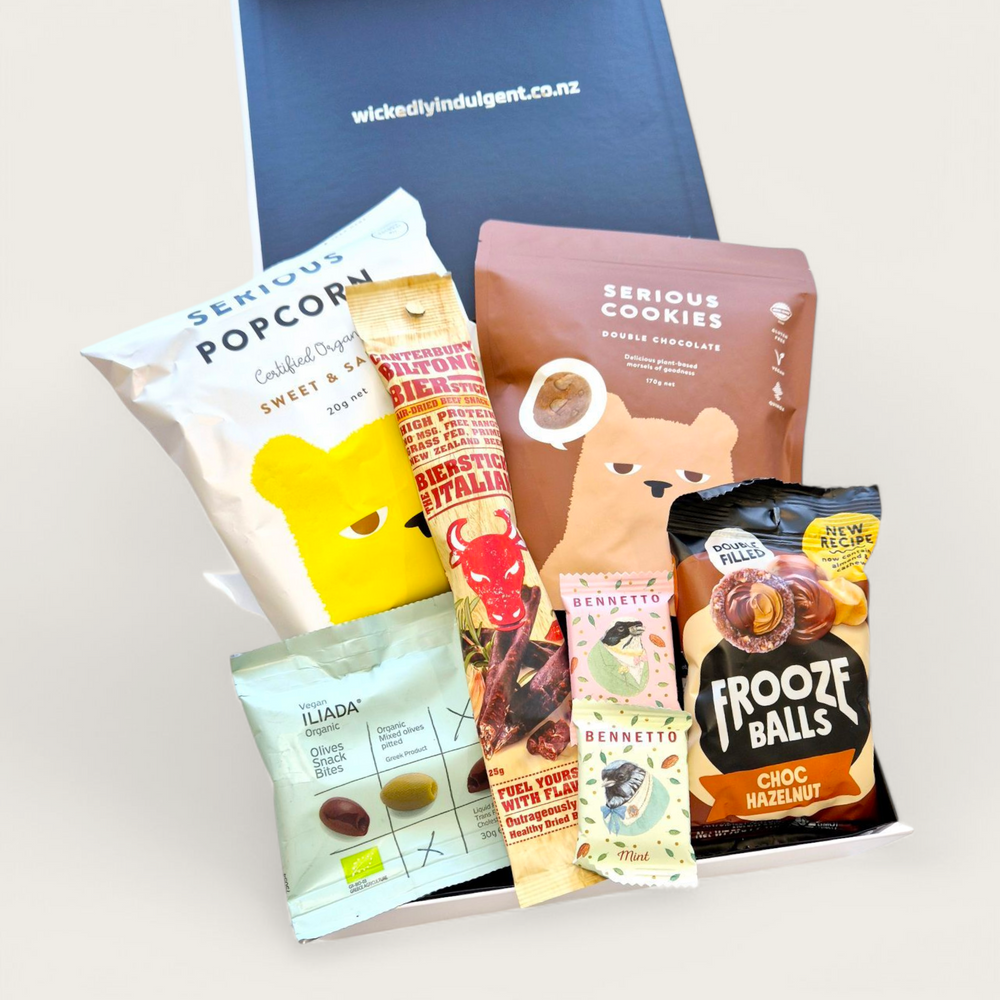 Snaccidents Happen Gift Box featuring gluten-free and dairy-free snacks including cookies, olives, popcorn, Frooze Balls, biersticks, and mini chocolate truffles. Delivered NZ-wide.