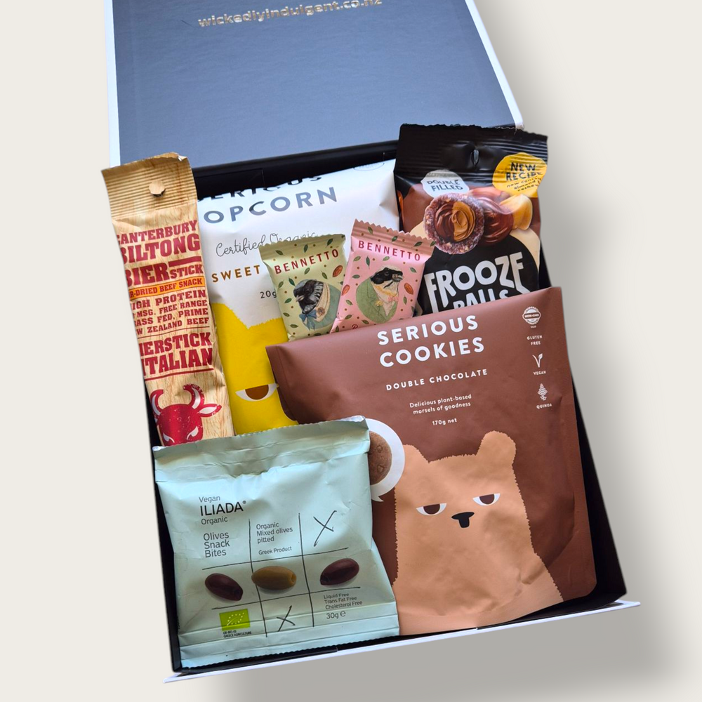 Snaccidents Happen Gift Box featuring gluten-free and dairy-free snacks including cookies, olives, popcorn, Frooze Balls, biersticks, and mini chocolate truffles. Delivered NZ-wide.