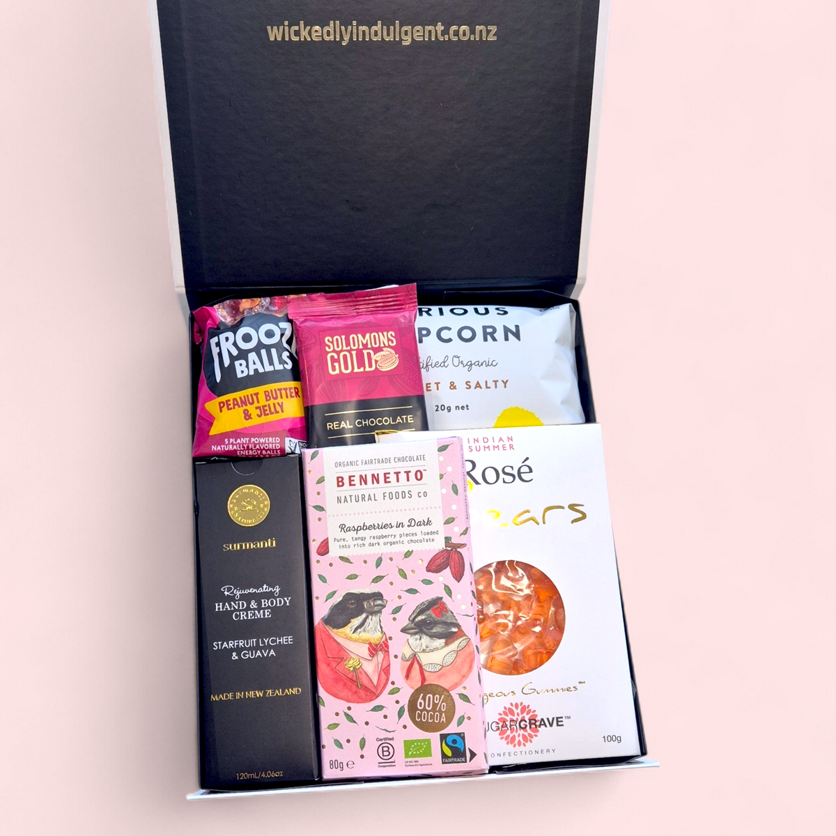 Gluten and dairy free gift box for her with chocolate, popcorn, sweets and Surmanti hand and body cream. Shipped NZ wide.