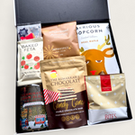 Let It Glow Snow Globe Gin Gift Box with LED-lit Clementine gin bottle, gold flakes, and artisan snacks in a festive black gift box.