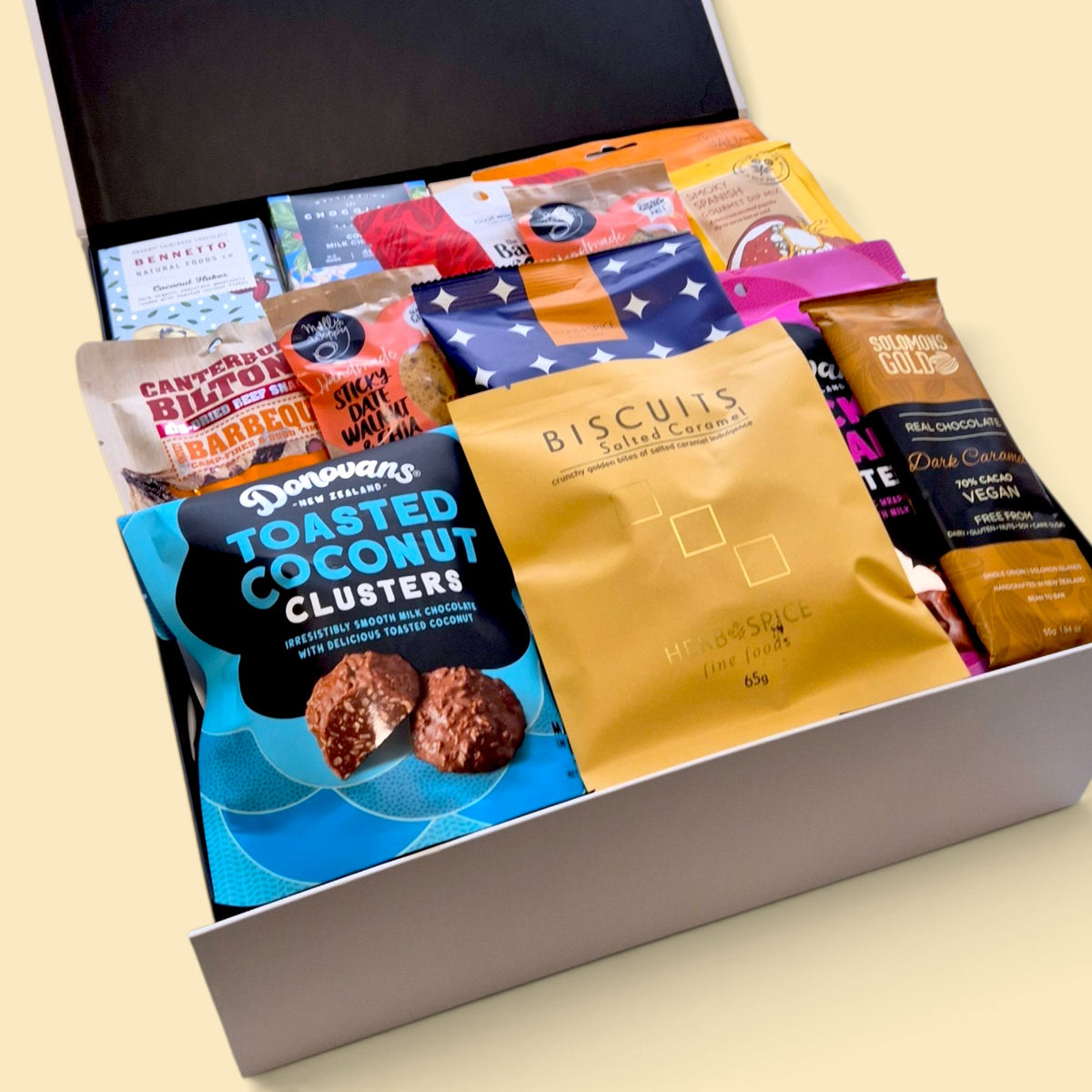 Non-alcoholic gourmet gift hamper presented in a Wickedly Indulgent gift box, packed with chocolates, snacks, cookies and savoury treats.