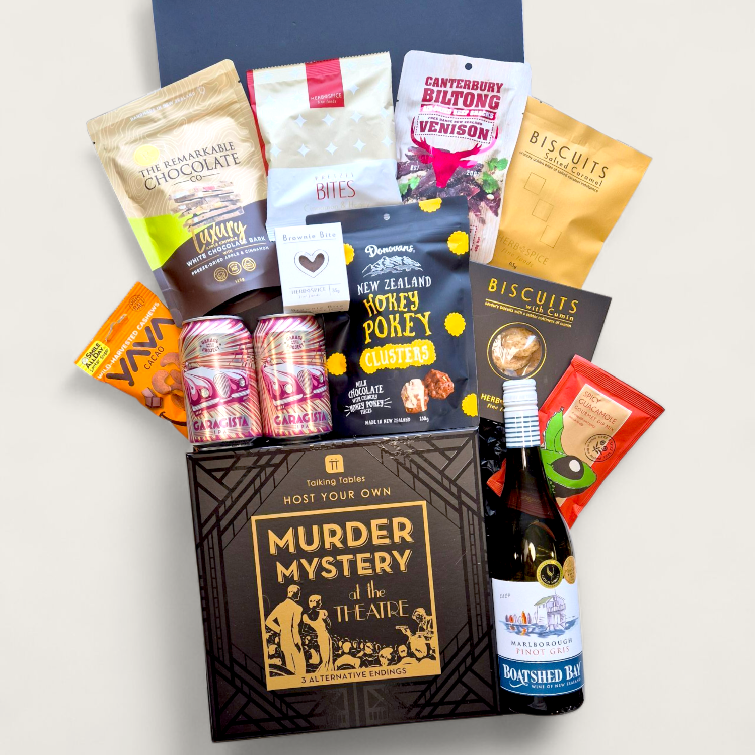 Ales, Alibis & Accusations gift box with craft beer, snacks, and a Murder Mystery game, perfect for team or Friendmas gifting.