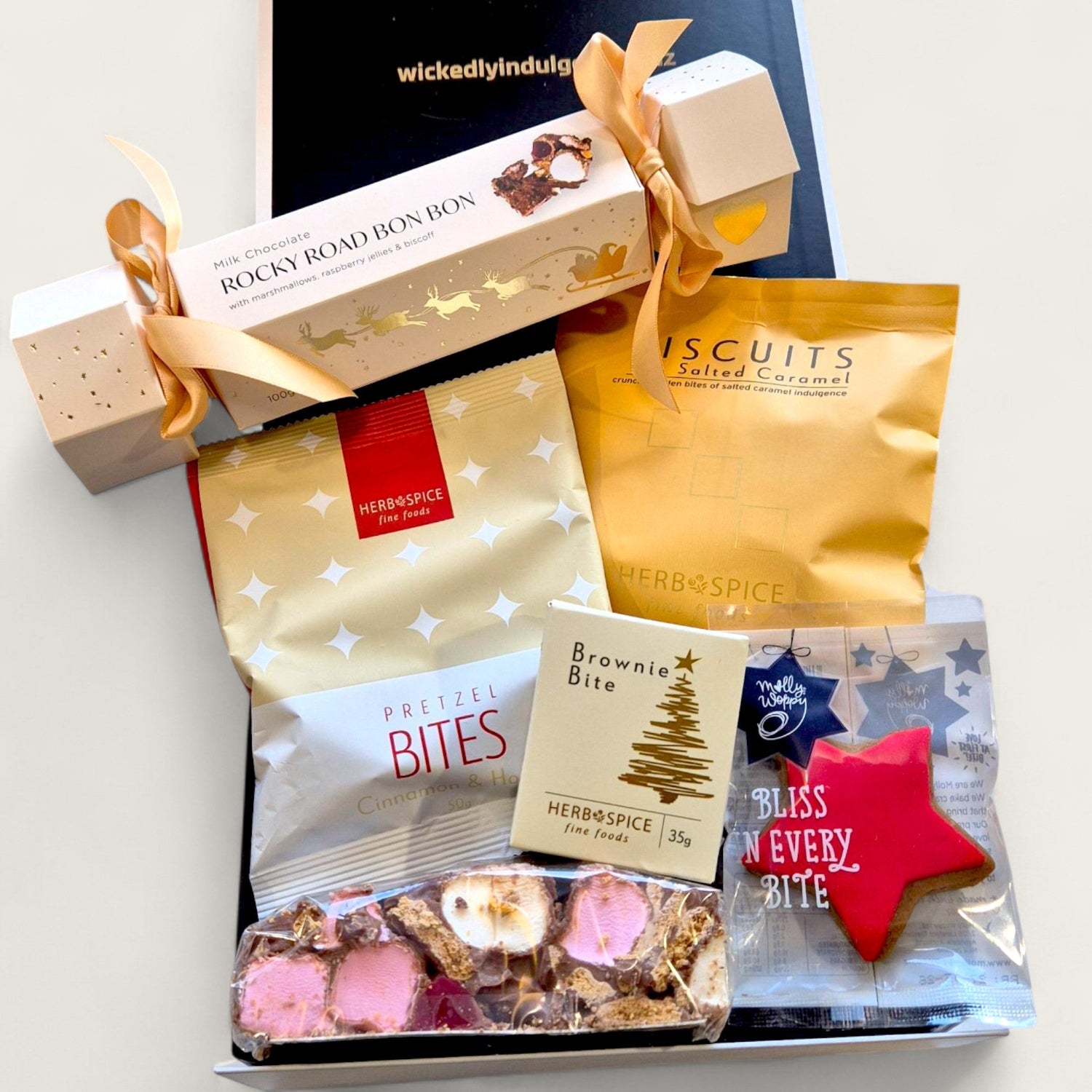 Christmas gift box called " Official gift of the naughty list" filled with festive treats, perfect for cheeky holiday gifting in New Zealand.