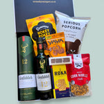Men's whisky gift box containing Glenfiddich 12 Year Scotch whisky 
bottles, Serious Popcorn, Yava cacao cashews, Donovan's chocolates, Roka cheese biscuits, and The Barn corn nibbles, presented in a 
black gift box, Wickedly Indulgent NZ