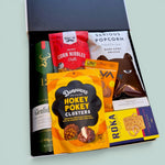 Wickedly Indulgent men's gift box with Glenfiddich whisky, popcorn, 
cacao cashews, cheese biscuits and snacks in a presented in a black and white wickedly indulgent box.