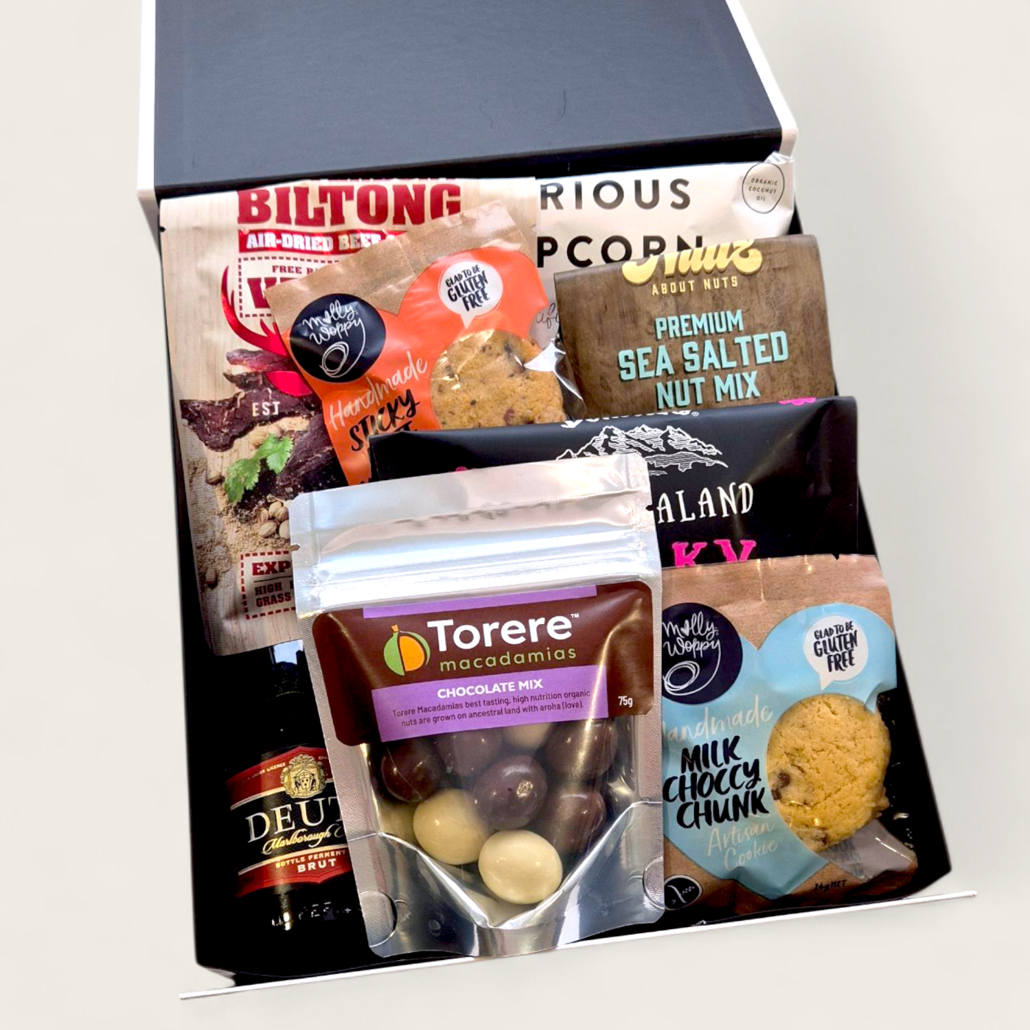 Pop, Snack & Chill hamper with premium New Zealand treats, chocolate, and Deutz bottle in modern gift packaging