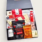 Christmas gift hamper “Sip, Snack & Sleigh” with NZ wine, gourmet popcorn, chilli cashews, pretzel bites, and festive sweets.