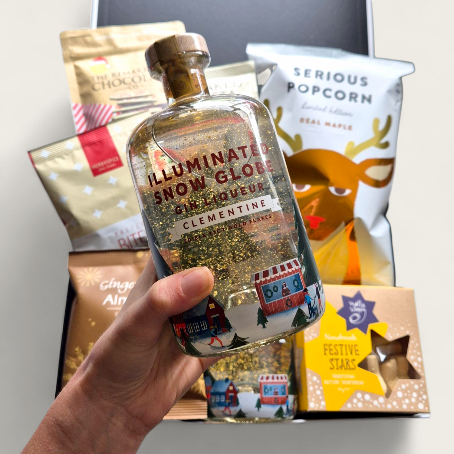 Illuminated Snow Globe Gin Liqueur bottle with glowing LED base and swirling edible gold flakes.