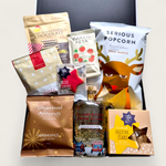 Let It Glow Snow Globe Gin Gift Box with LED-lit Clementine gin bottle, gold flakes, and artisan snacks in a festive black gift box.