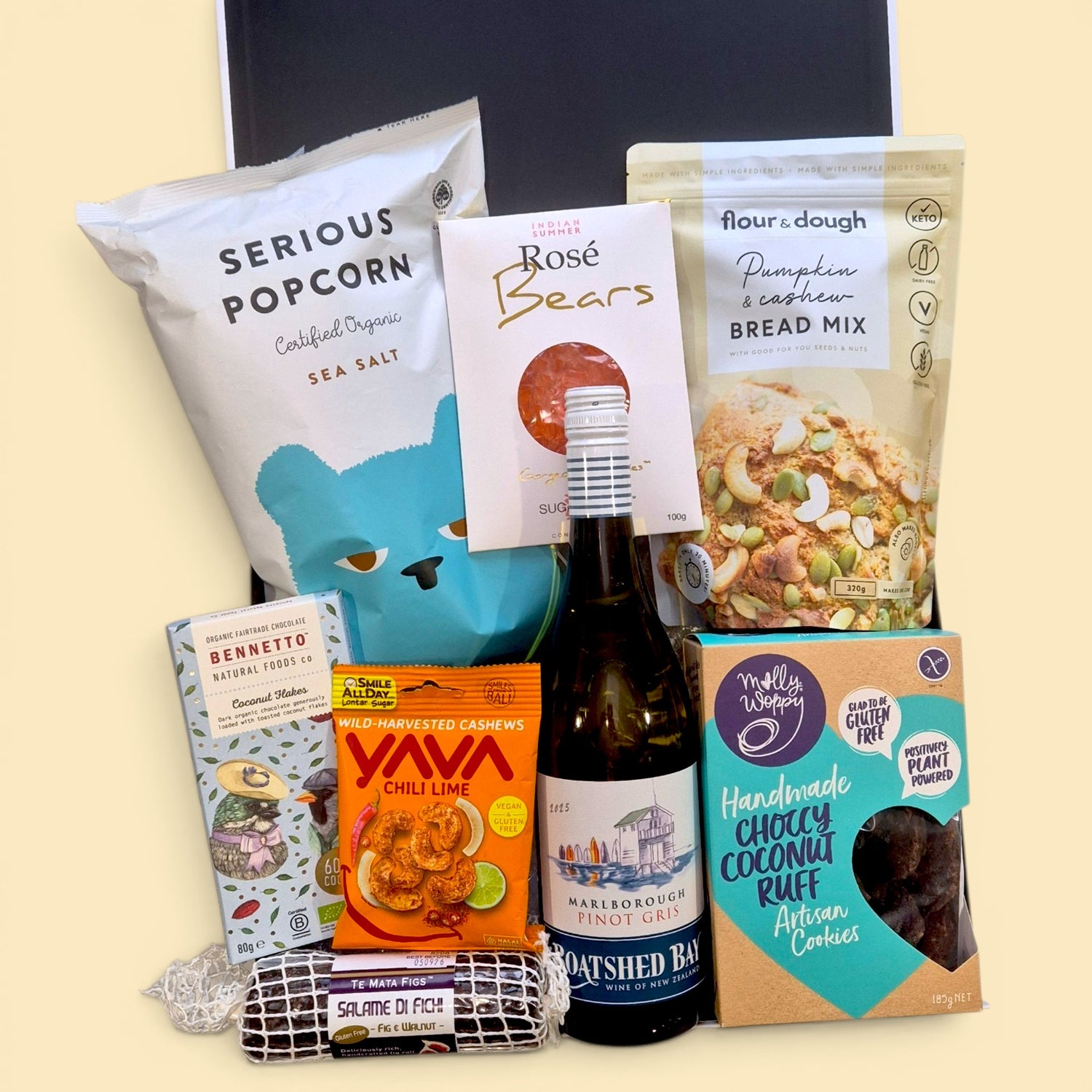Gluten free and dairy free wine gift hamper with chocolate, cookies, popcorn, cashews, gummy bears and sweet treats.