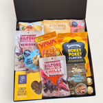Non alcoholic gift hamper with an assortment of sweet and savoury snacks. Presented in a modern gift box.