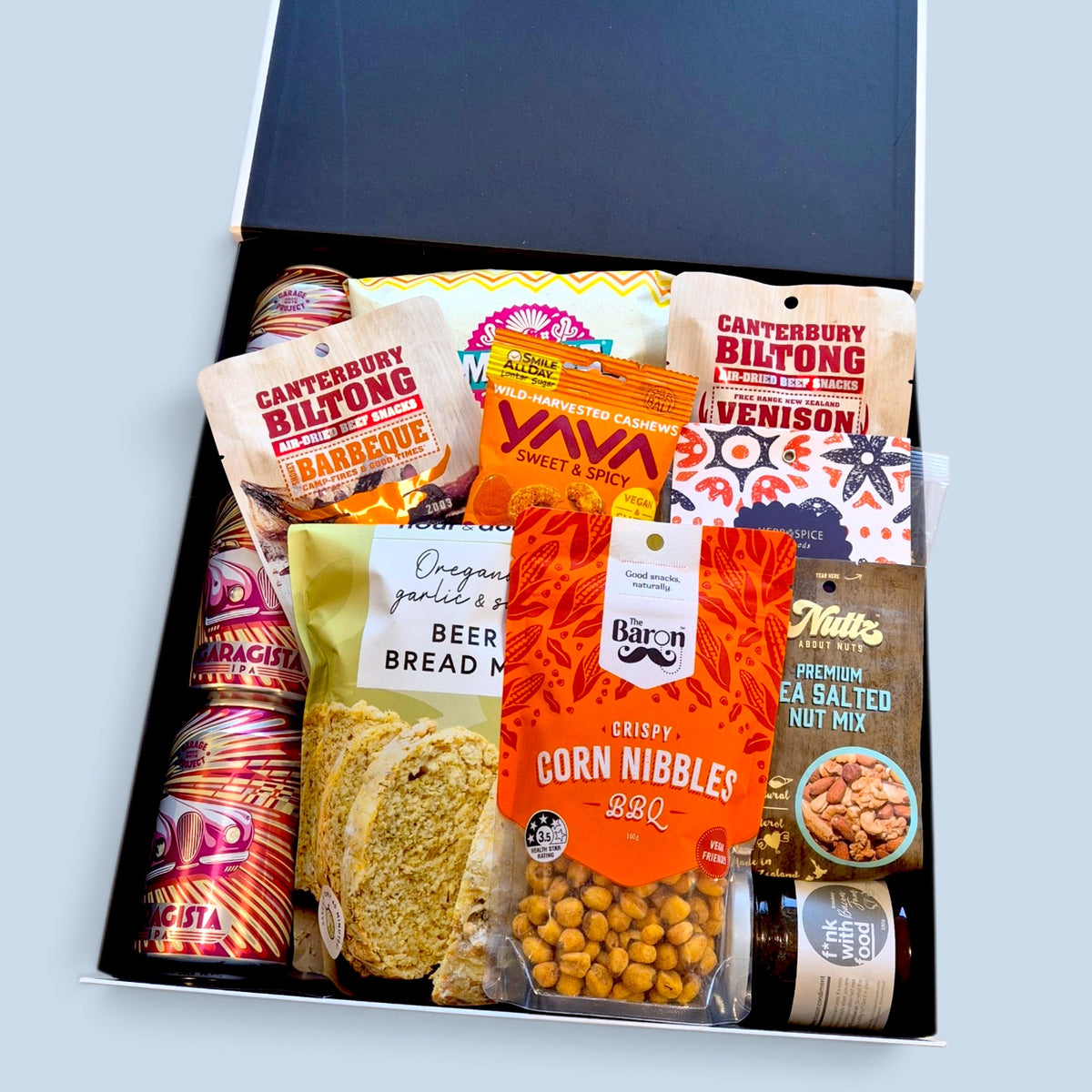 Premium craft beer and savoury snack gift hamper featuring beer, biltong, chips, cashews, nut mix and beer bread mix in a Wickedly Indulgent gift box.