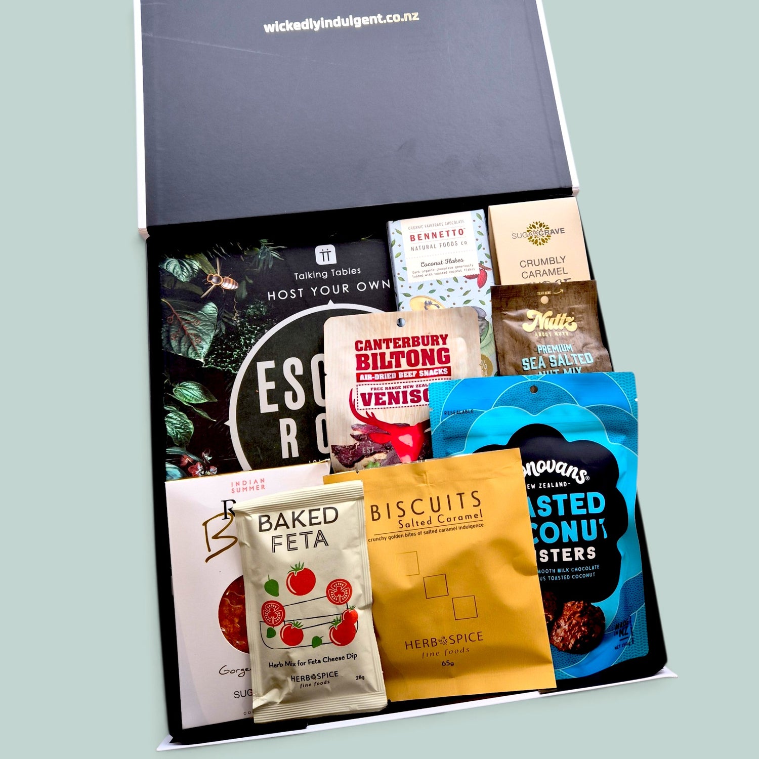 Non-alcoholic gift box with Escape Room or Murder Mystery game, artisan snacks, and clever puzzles — perfect for families, friends, or teams.
