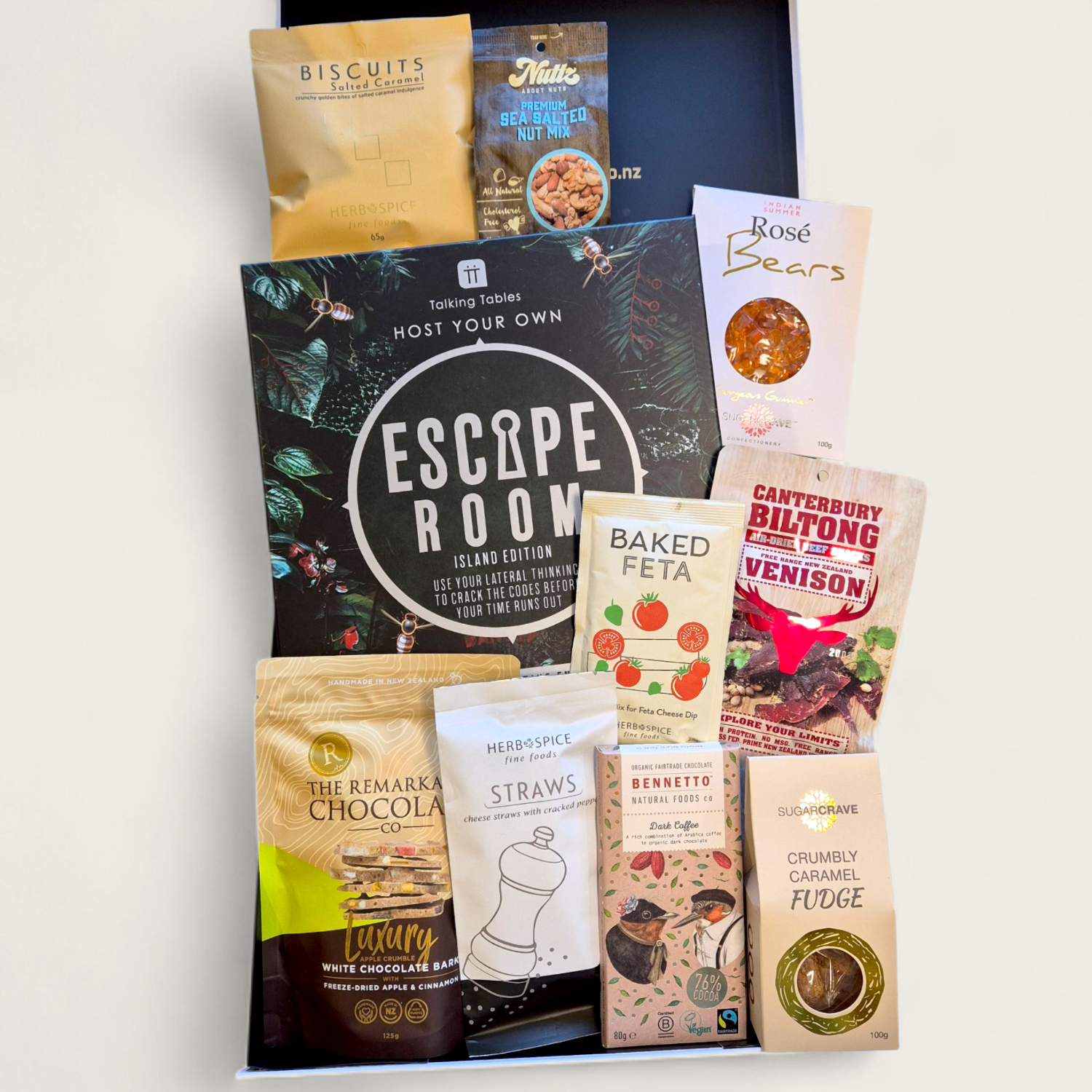 Non-alcoholic gift box with Escape Room or Murder Mystery game, artisan snacks, and clever puzzles — perfect for families, friends, or teams.