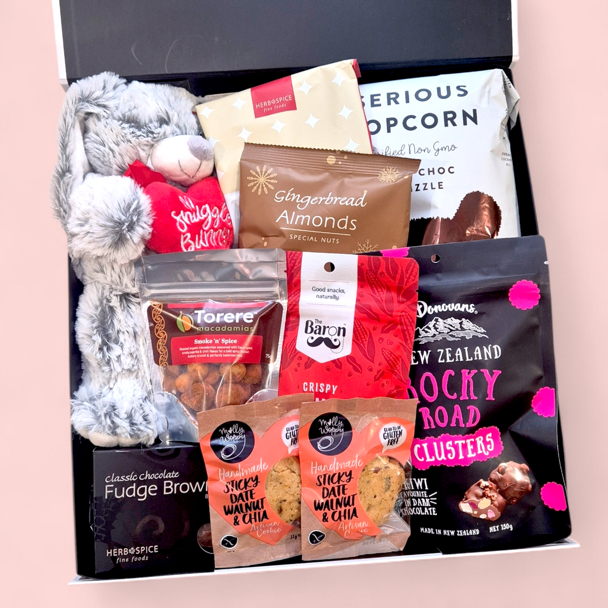 Valentine’s  gift box featuring gourmet treats, chocolate snacks, savoury nibbles and a plush snuggle bunny presented in a modern gift box