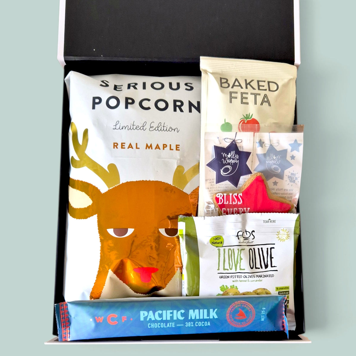 Christmas Cracker gift hamper featuring a chocolate-filled Christmas cracker, popcorn, festive gingerbread, chocolates and gourmet snacks, beautifully presented in a Wickedly Indulgent gift box